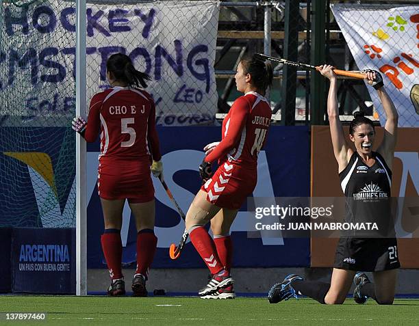 New Zealand's Cathryn Finalyson celebrates after scoring the team's first goal next to South Korea's Eun Ji Cho and Yu Mi Jeon during their Champions...