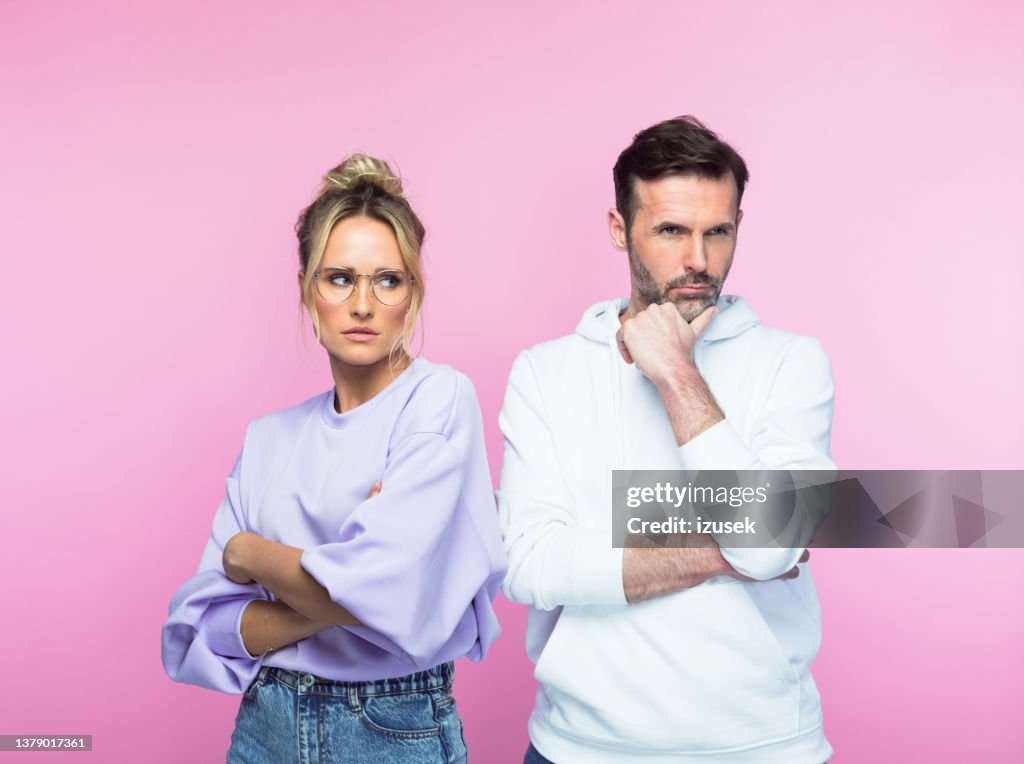 Angry mid adult couple looking away