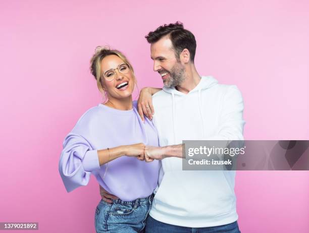 happy mid adult couple giving fist bump - introducing girlfriend stock pictures, royalty-free photos & images