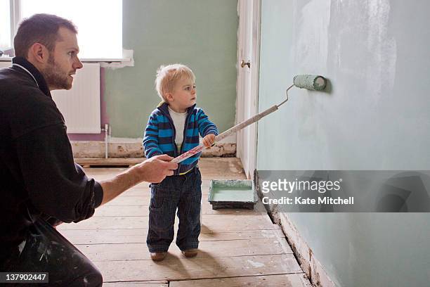 father and son painting wall - children room wall stock pictures, royalty-free photos & images