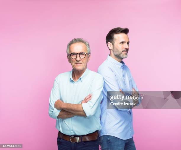 confident senior man with arms crossed by son - handsome stock pictures, royalty-free photos & images