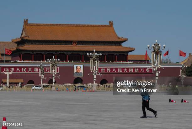 Man struggles in strong wind as he walks in a nearly empty Tiananmen Square before the opening session of the Chinese Peoples Political Consultative...