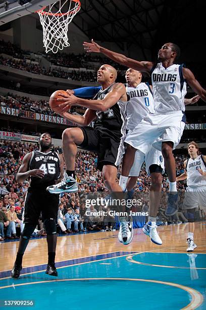 Richard Jefferson of the San Antonio Spurs drives the ball against Rodrigue Beaubois and Shawn Marion of the Dallas Mavericks on January 29, 2012 at...