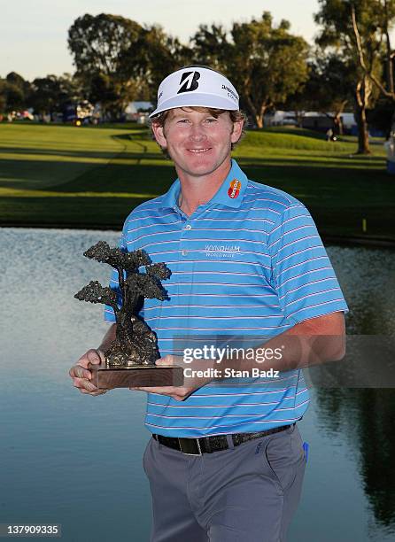 Brandt Snedeker poses with the trophy after the final round of the Farmers Insurance Open on the South Course of the Torrey Pines Golf Course on...