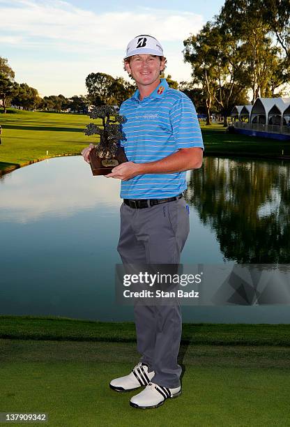 Brandt Snedeker poses with the trophy after the final round of the Farmers Insurance Open on the South Course of the Torrey Pines Golf Course on...