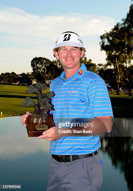 Brandt Snedeker poses with the trophy after the final round of the Farmers Insurance Open on the South Course of the Torrey Pines Golf Course on...