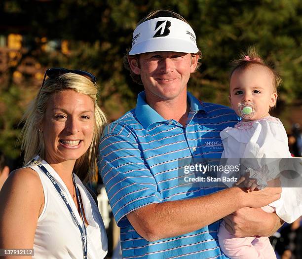 Brandt Snedeker with his wife Mandy and 11-month old daughter Lily pose for a photo on the 18th green after the final round of the Farmers Insurance...