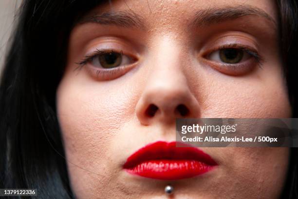 piercing,close-up portrait of young woman - alexis lee stock pictures, royalty-free photos & images