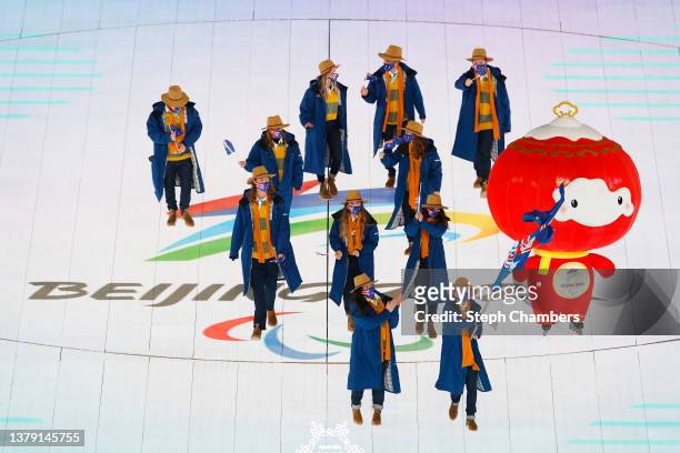 Flag bearers Melissa Perrine and Mitchell Gourley of Team Australia lead their team out during the Opening Ceremony of the Beijing 2022 Winter...