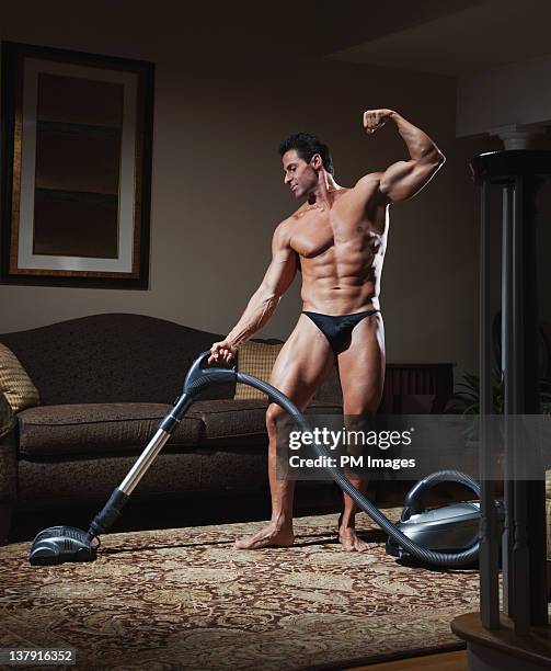 body builder vacuuming - man housework stock pictures, royalty-free photos & images