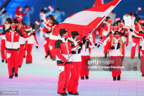 Flag bearers Barbara Aigner and Markus Salcher of Team Austria lead their team out during the Opening Ceremony of the Beijing 2022 Winter Paralympics...