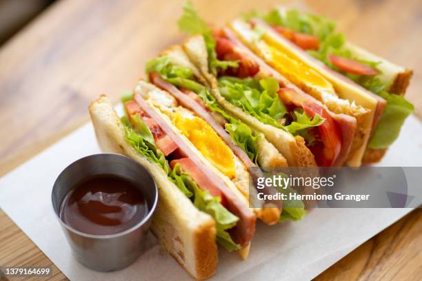 club sandwich with cheese, cucumber, tomato, ham and eggs. top view - cheese top view stockfoto's en -beelden