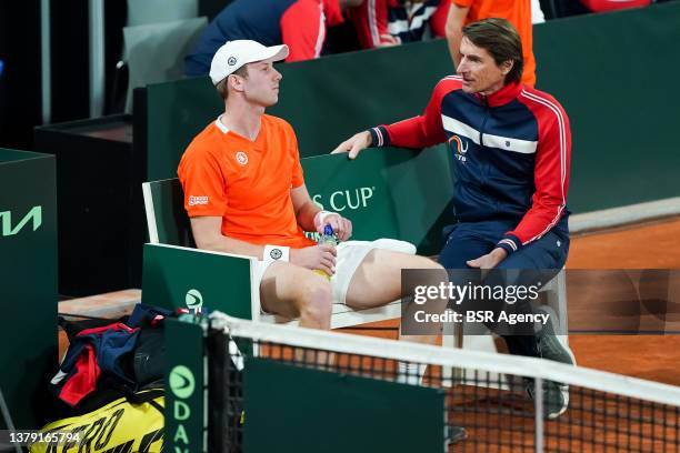 Botic van de Zandschulp of the Netherlands is coached by Team Netherlands captain Paul Haarhuis in his singles match against Alexis Galarneau of...