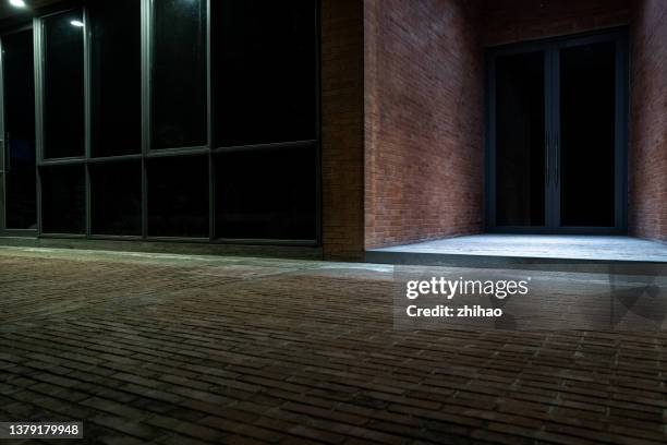 night view of open space outside red brick building - pavement stock pictures, royalty-free photos & images