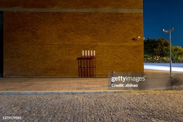 night view of side road outside brick wall building - empty lot night 個照片及圖片檔