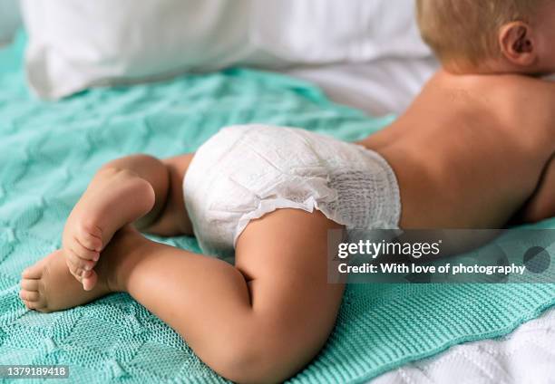 cute baby boy 10-11 months playing in baby pants white diaper - blöja bildbanksfoton och bilder