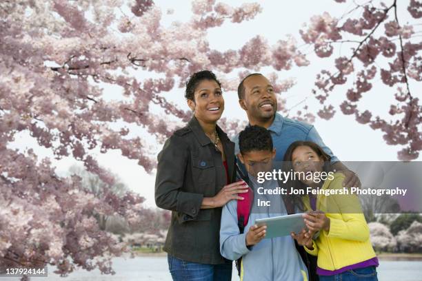 african american family using digital tablet on vacation - potomac maryland stock pictures, royalty-free photos & images