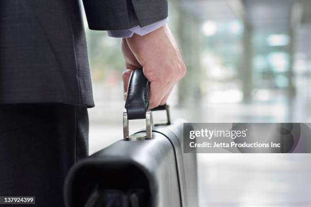 mixed race businessman carrying briefcase - briefcase 個照片及圖片檔