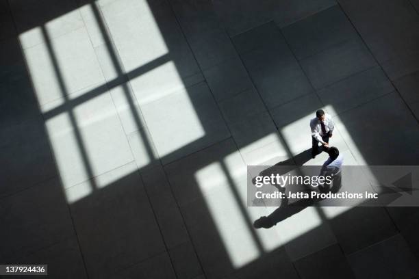 businessmen shaking hands in lobby - chance encounter stock pictures, royalty-free photos & images