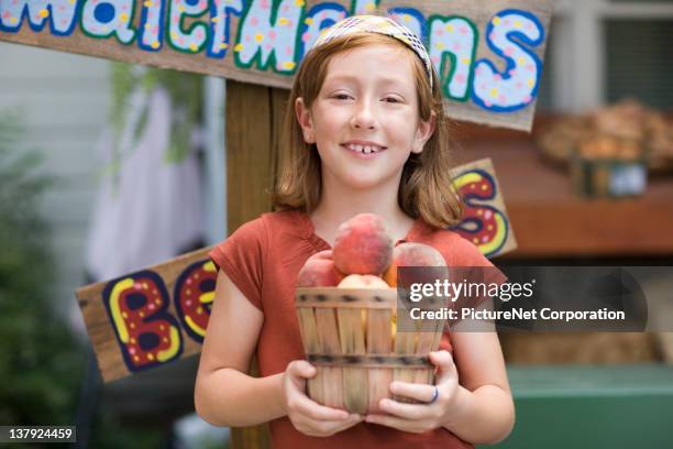 caucasian girl holding basket of peaches - atlanta georgia food stock pictures, royalty-free photos & images
