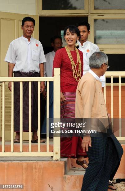 Myanmar opposition leader Aung San Suu Kyi leaves after a visit to a polling station in the constituency where she stands as a candidate in Kawhmu on...