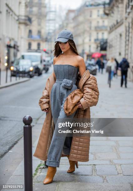 Olivia Culpo is seen wearing brown Bottega Veneta pouch bag, grey cap, high waisted pants with belt bag, off shoulder top, brown coat J’amemme, Saint...