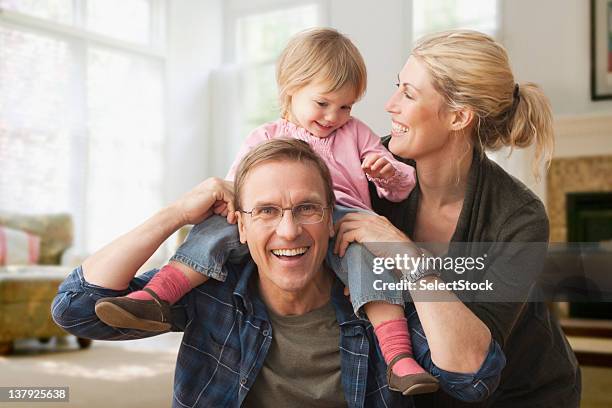 daughter playing  with parents - west new york new jersey stock pictures, royalty-free photos & images