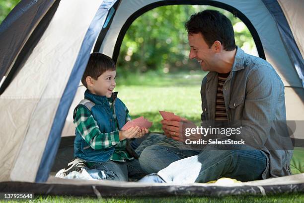 father and son outdoors camping - camping games stockfoto's en -beelden