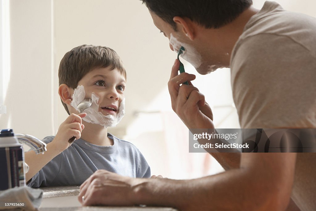 Father and son shaving together