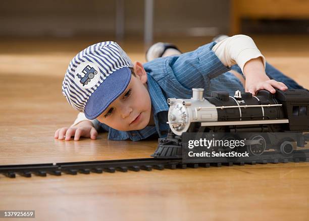 young boy playing with toy trains - kid conductor stock pictures, royalty-free photos & images