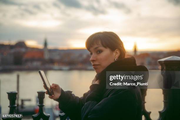 young woman on the street using smartphone - no 2012 chilean film stockfoto's en -beelden