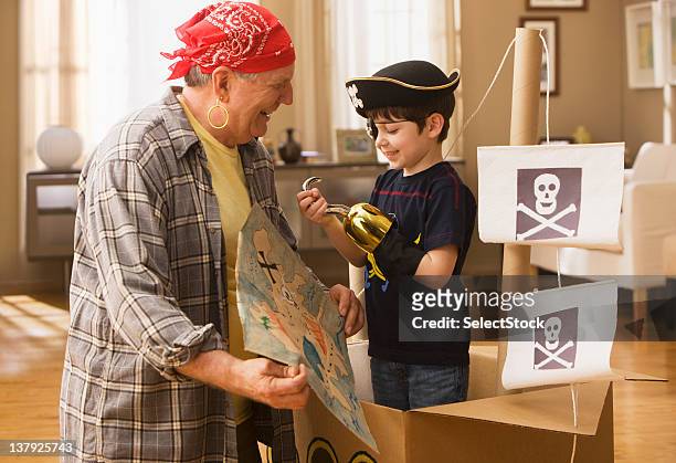 grandfather and grandson playing pirates - earring hook stock pictures, royalty-free photos & images