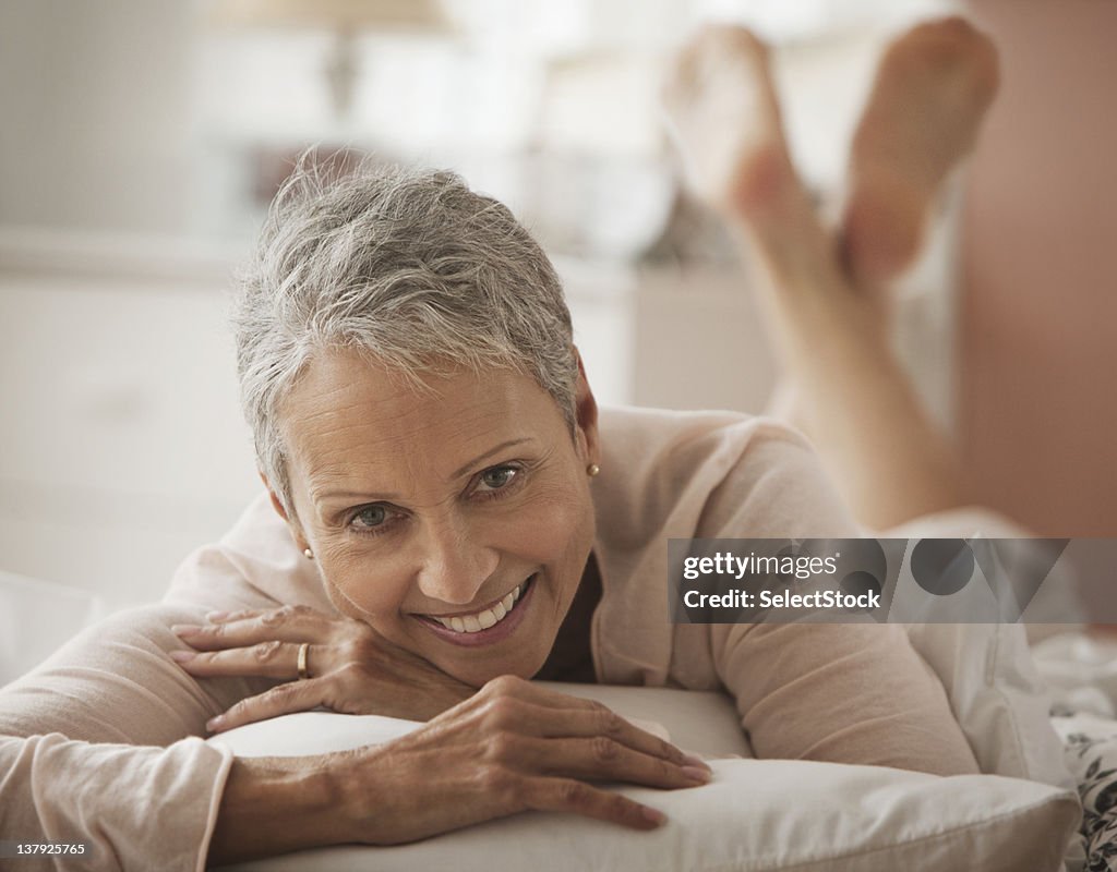 Woman laying playfully in bed