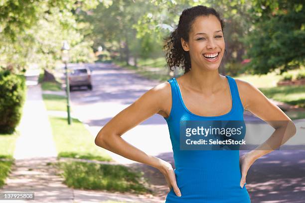 woman with hands on hips outdoors - woman in sports jersey stock pictures, royalty-free photos & images
