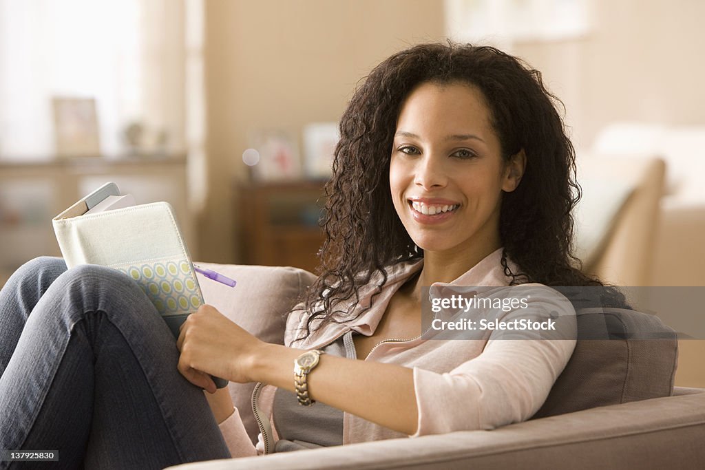 Smiling woman writing in journal