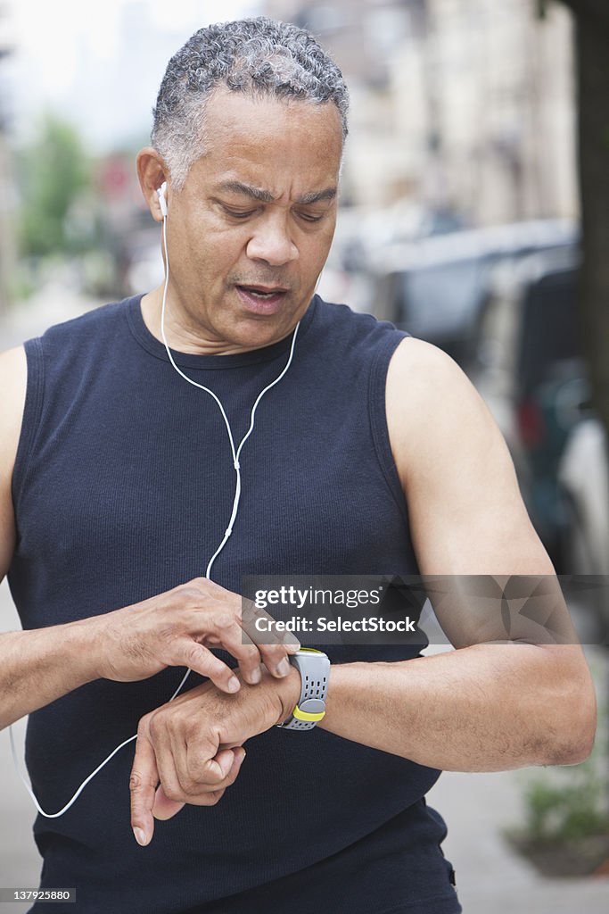 Male runner checking time