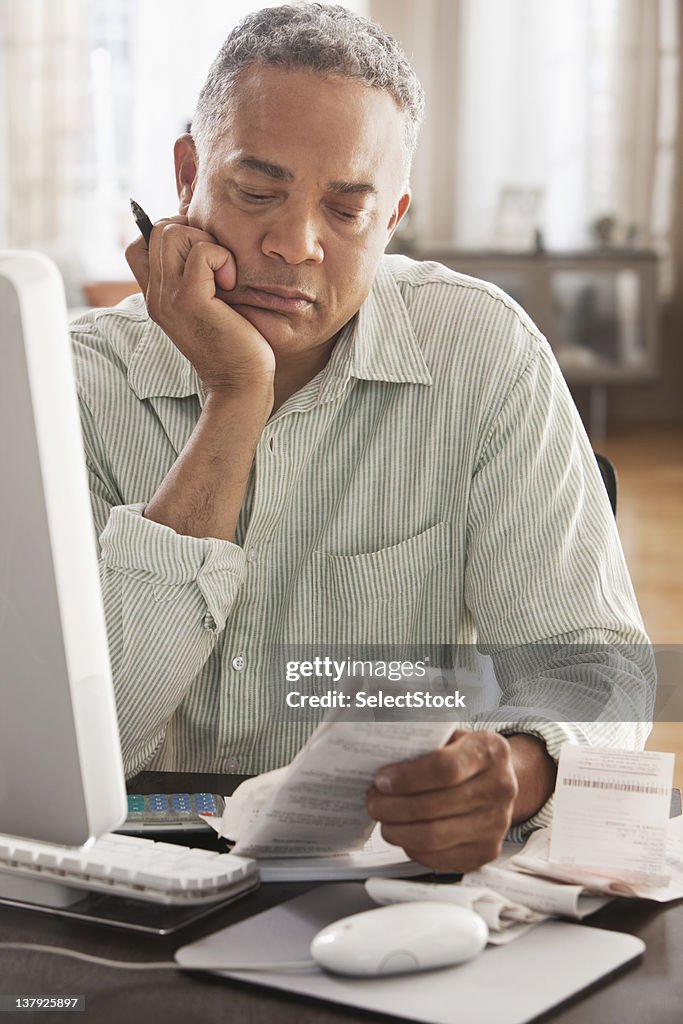 Older man looking at receipts