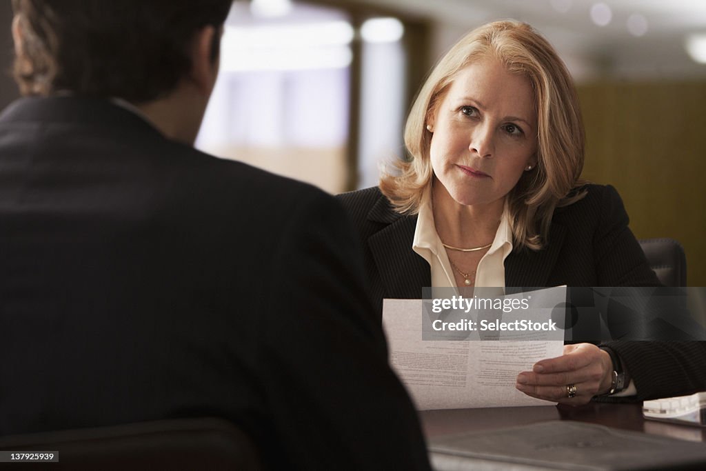 Mature businesswoman interviewing male candidate
