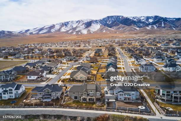 housing development adjacent to a lake - howse peak stock pictures, royalty-free photos & images