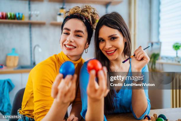 cheerful eggs coloring - female friendship painting stock pictures, royalty-free photos & images