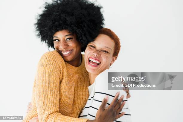 two female friends embrace and smile joyfully - friends smile bildbanksfoton och bilder