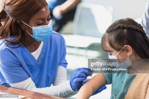 nurse prepares injection site - booster dose stock pictures, royalty-free photos & images