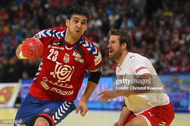 Kasper Nielsen of Denmark defends against Nenad Vuckovic of Serbia during the Men's European Handball Championship final match between Serbia and...