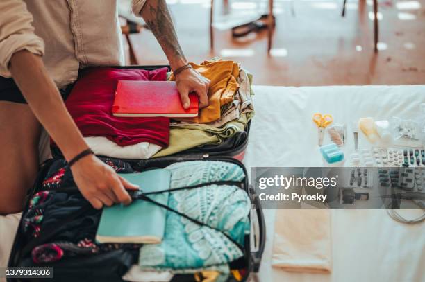 the man is packing for the trip - medical tourism stock pictures, royalty-free photos & images