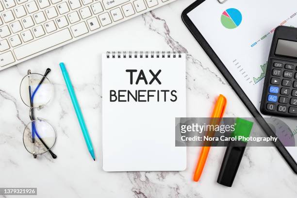 tax benefits text on clipboard - tax reform stock-fotos und bilder