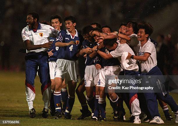 Japanese players and coaches celebrate Masayuki Okano's golden goal during the 1998 France World Cup Asian Play-off match between Japan and Iran at...