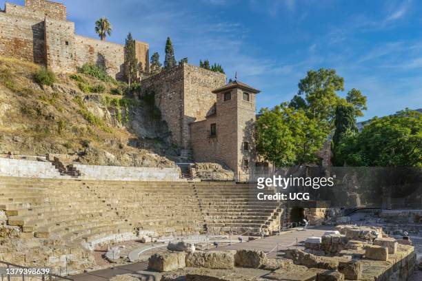 The Roman theatre beneath the walls of the Moorish Alcazaba, or fortress, Malaga, Costa del Sol, Malaga Province, Andalusia, southern Spain. The...