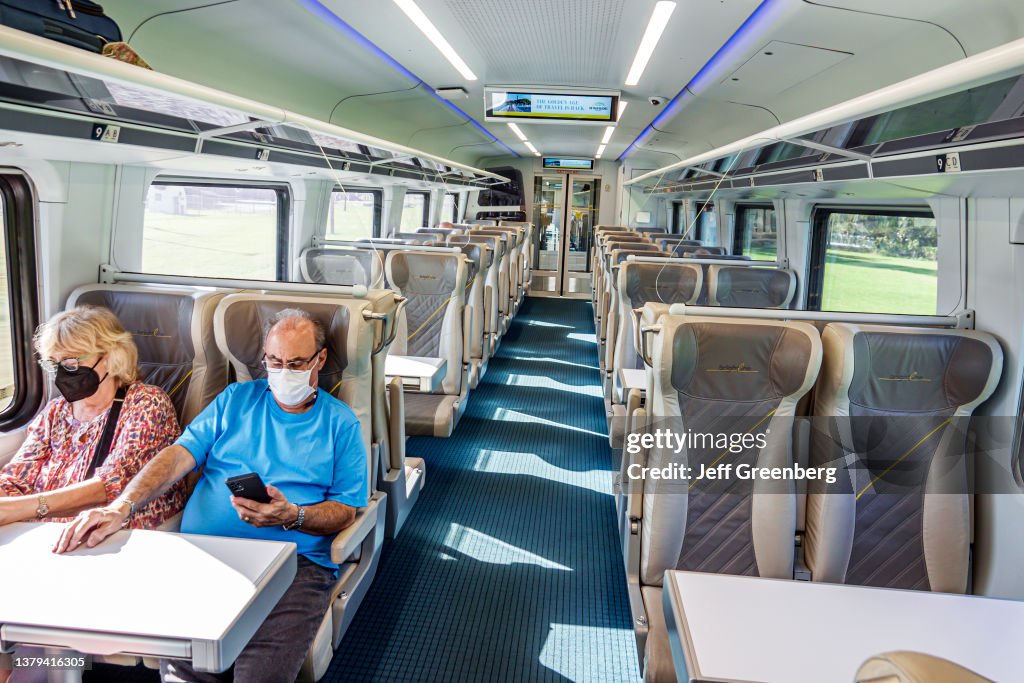 Miami, Florida, Brightline, couple riding Smart Class cabin of train