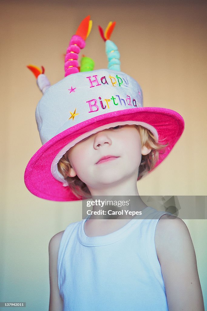 Boy with birthday cake hat