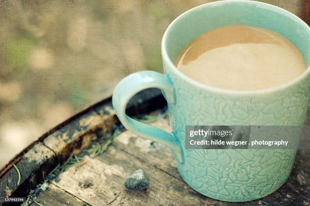 Mug of coffee on wooden table